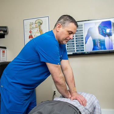 Dr. Brian McGinnis Adjusting A Patient