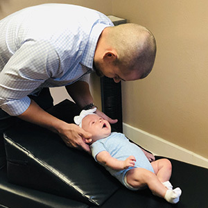 Dr. Owens adjusting an infant patient