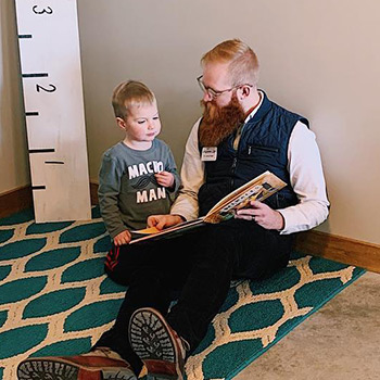 Dr. Spencer reading to a young boy