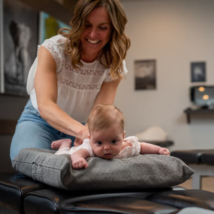 Smiling while adjusting baby