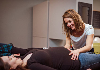 Dr. Lisa adjusting pregnant mom