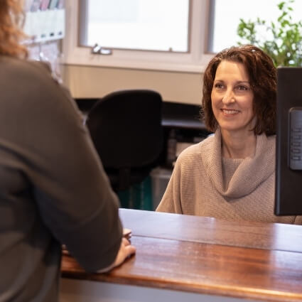 patient talking to our front desk staff