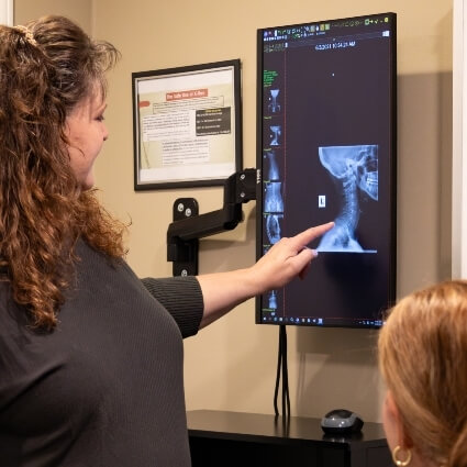 chiropractor showing patient xrays