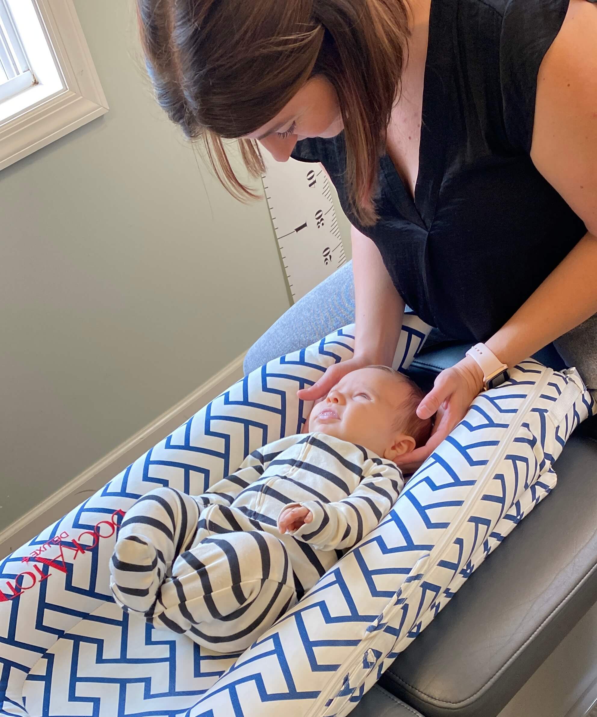 Dr. Shadley adjusting a baby