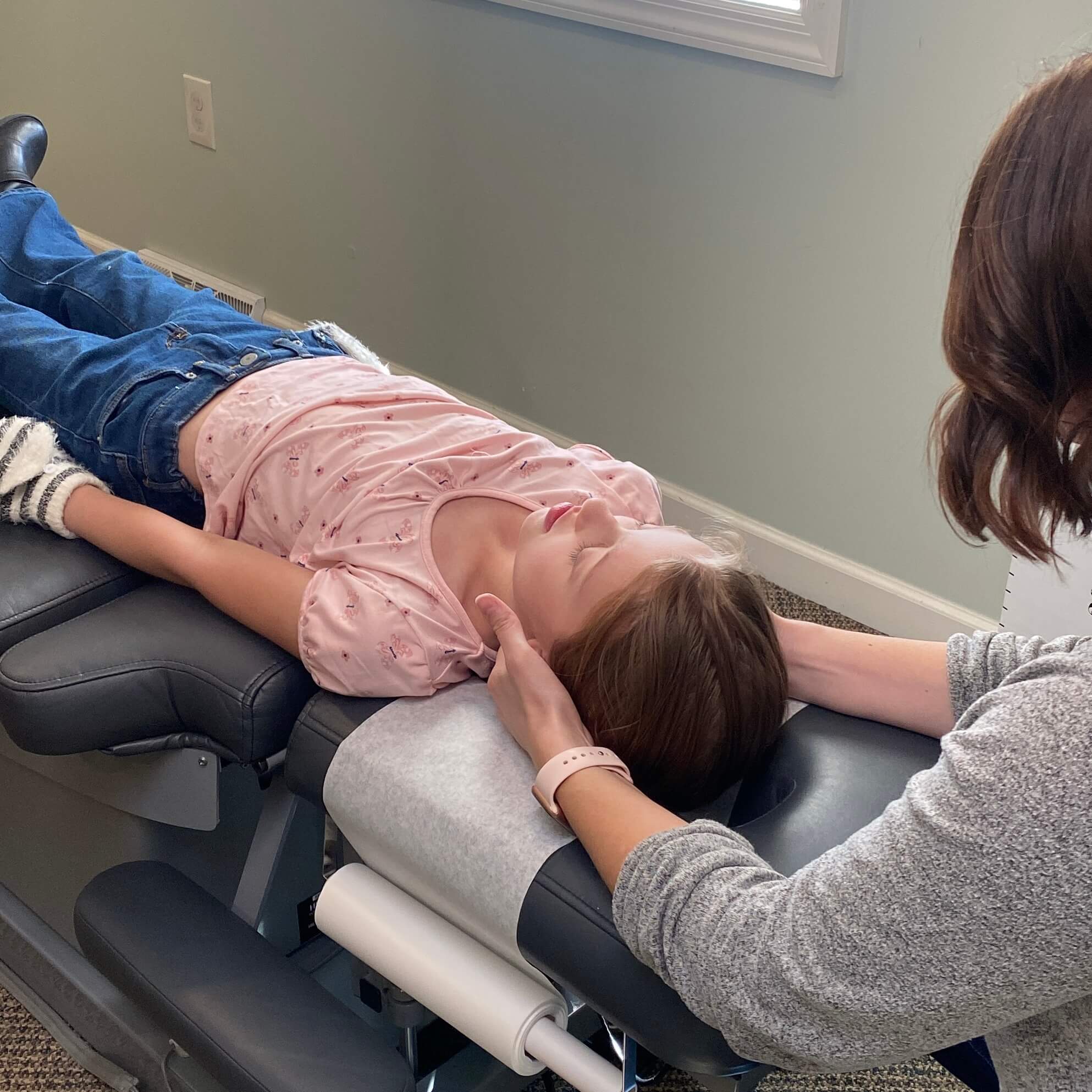 Dr. Shadley adjusting a child