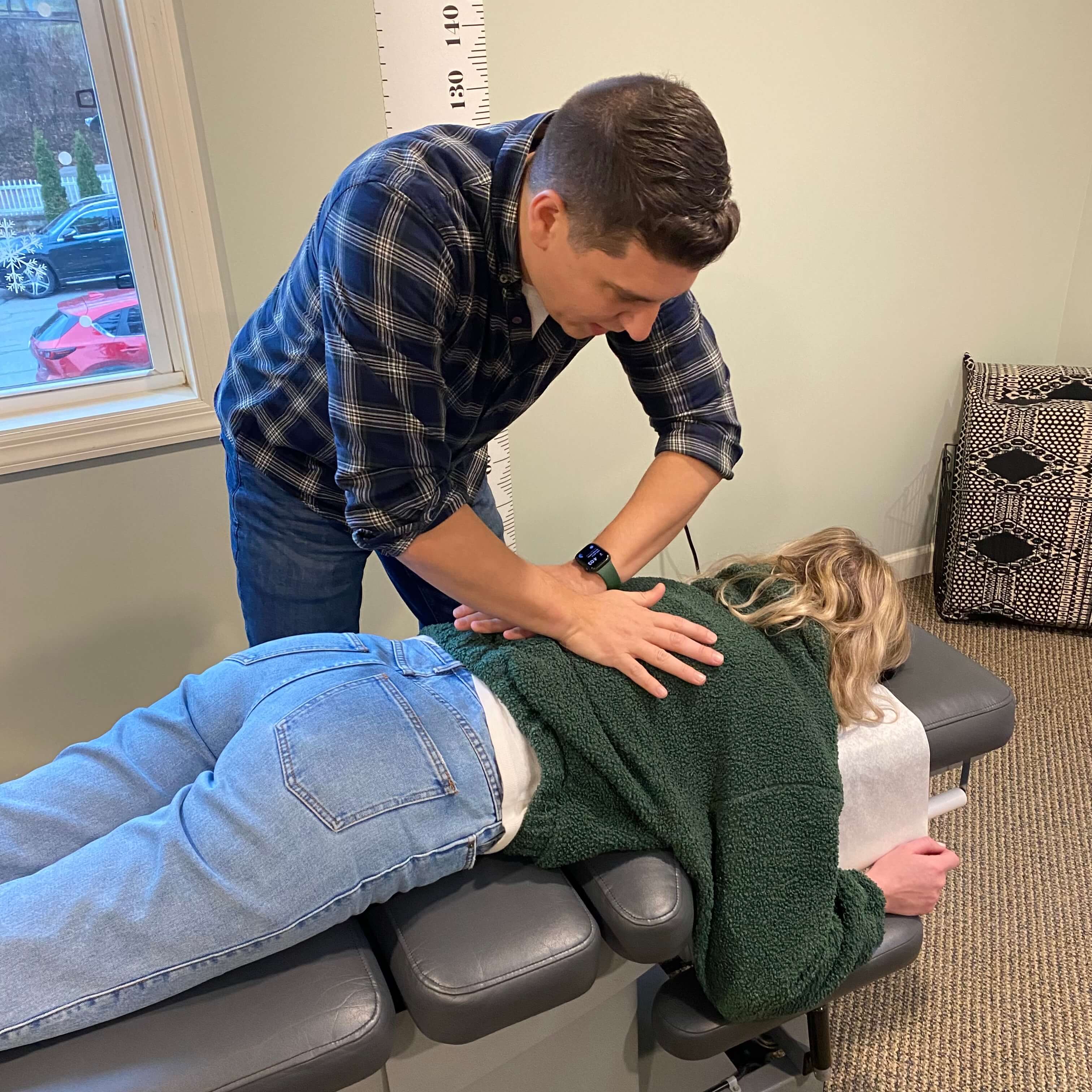 Dr. Tom adjusting a patient