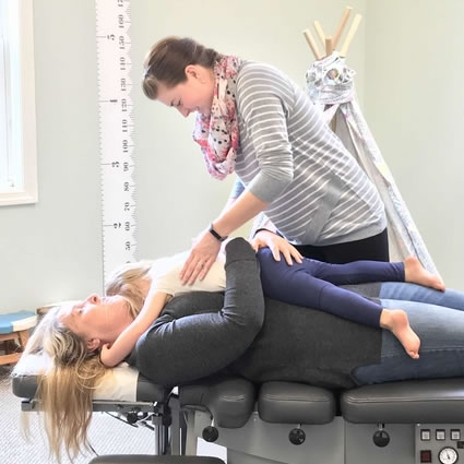 Dr. Shadley adjusting toddler on mom