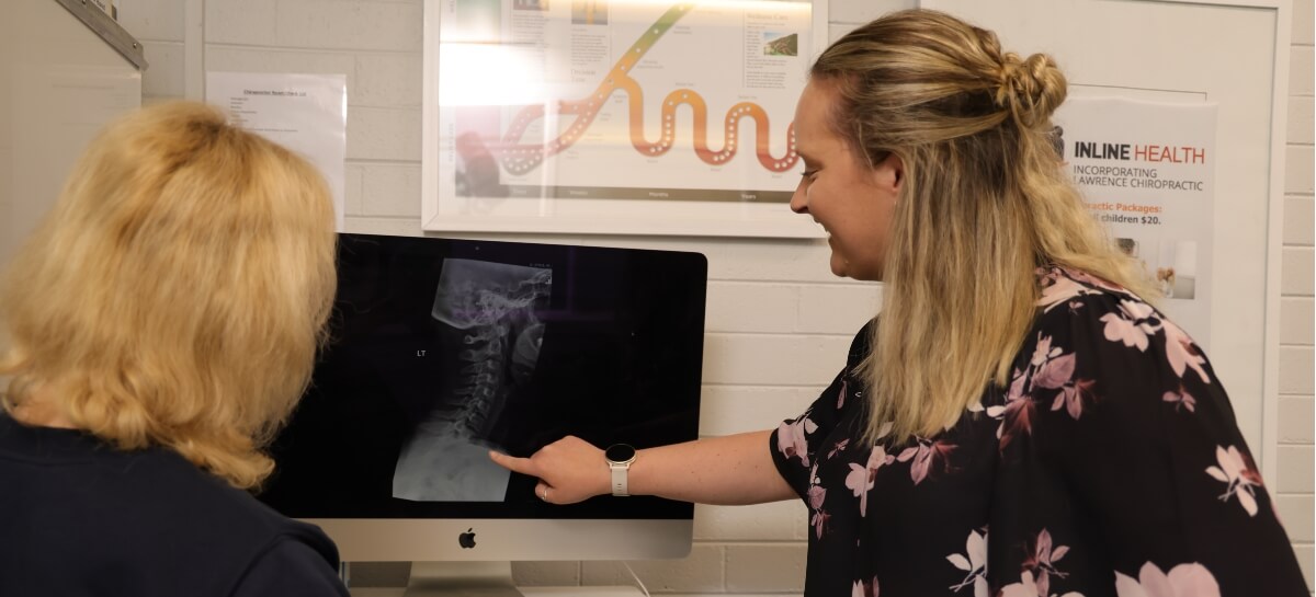 Chiropractor discussing x-ray with patient