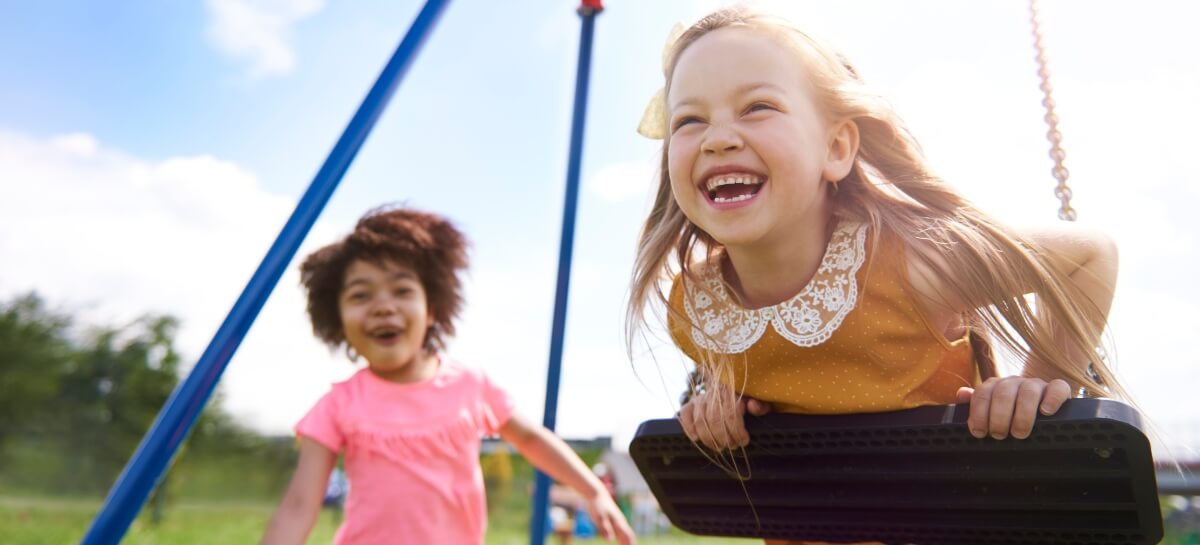 Little girls playing on a swing