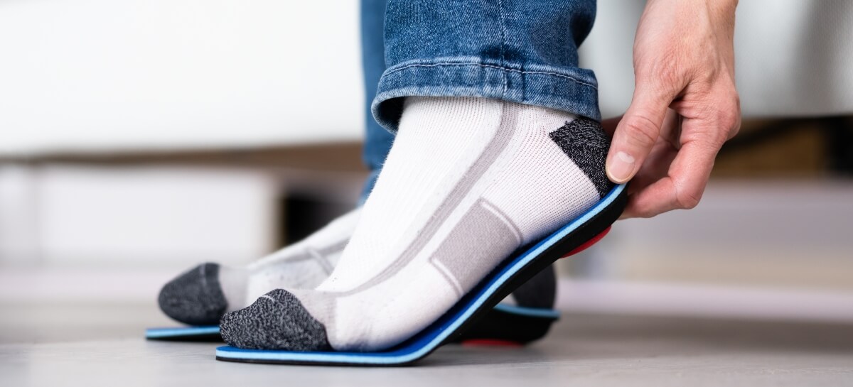 Man fitting orthotics