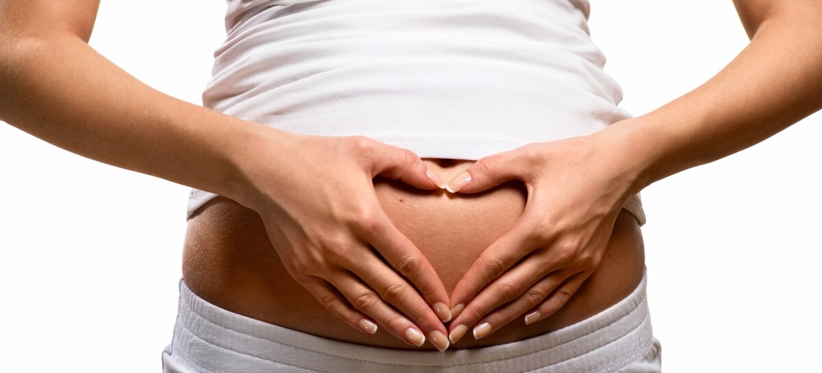 Pregnant woman making heart shape with hands