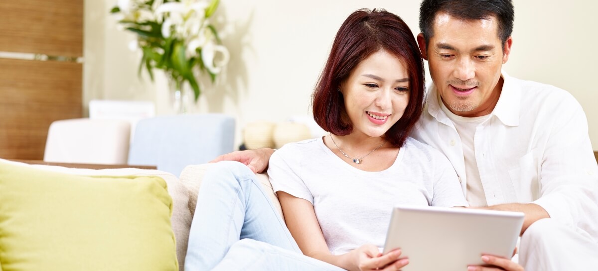 Smiling couple looking at tablet