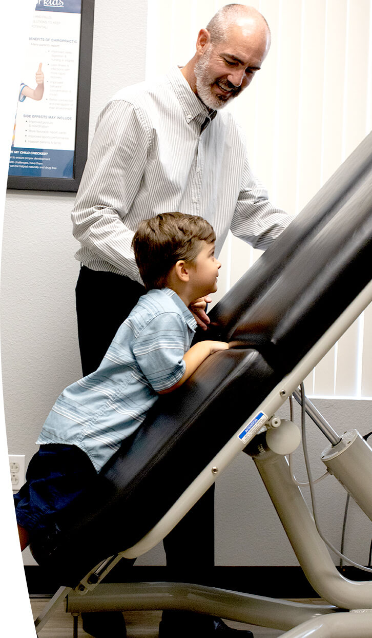 Doc with little boy on adjusting table