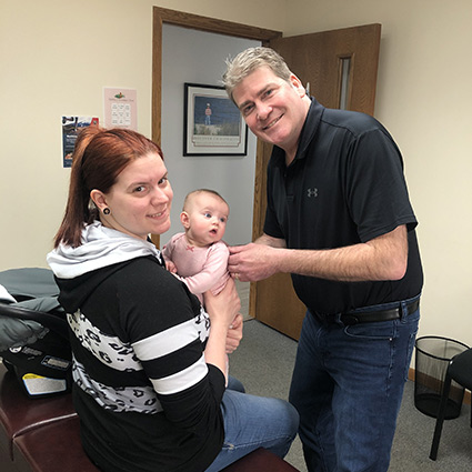 Dr Roth adjusting baby