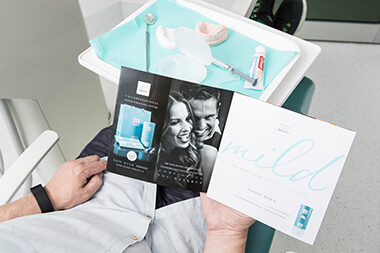 Patient reading Brochure for Teeth Whitening