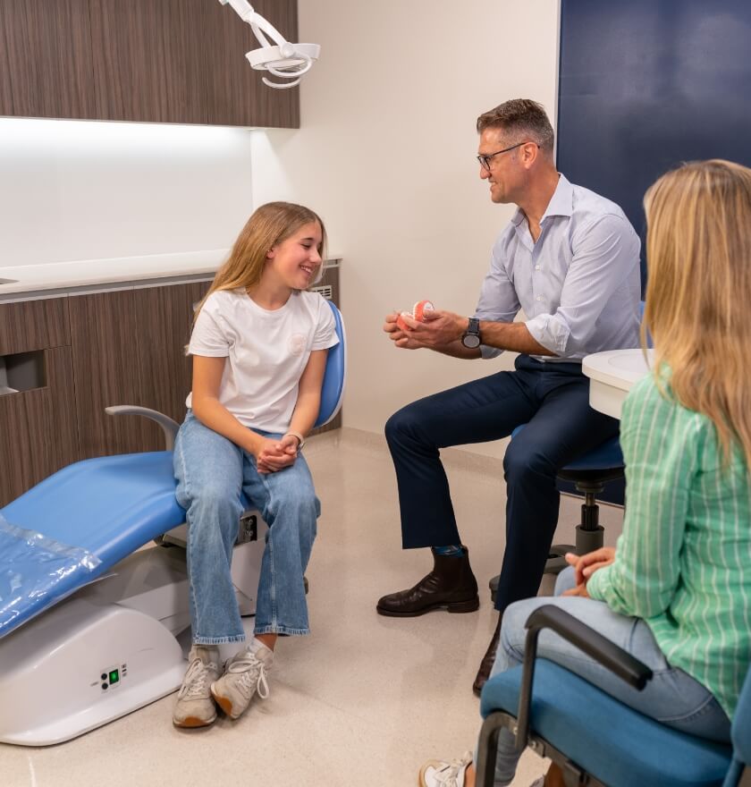 Chiropractor talking to patient