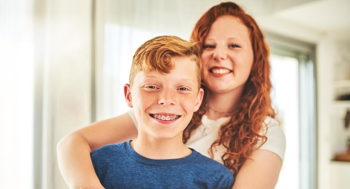 Boy with braces and his older sister