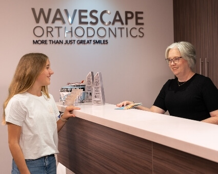 Receptionist greeting female patient