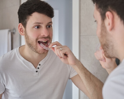 Man fitting invisalign