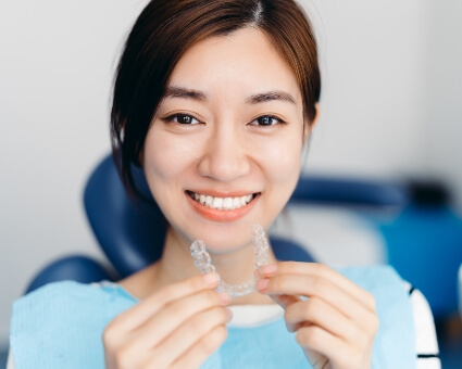 Woman holding spark clear aligners