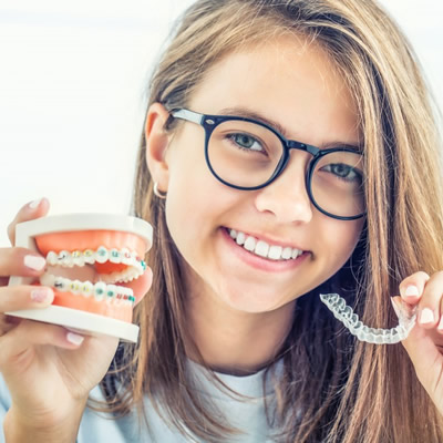 teen holding wire and clear braces model