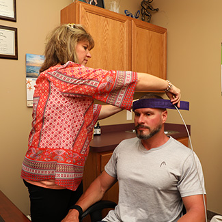 Dr. Wendy preparing patient for biofeedback