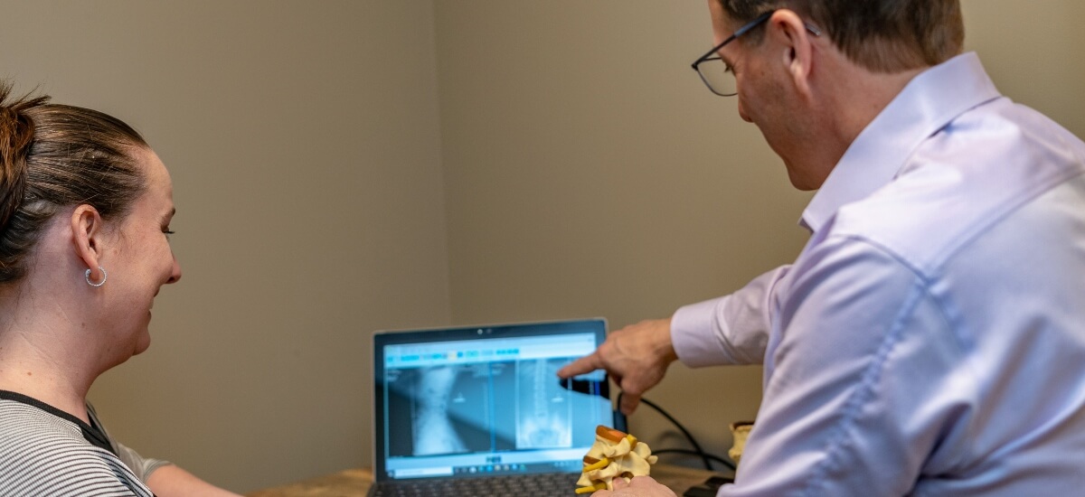 Chiropractor discussing x-rays with patient
