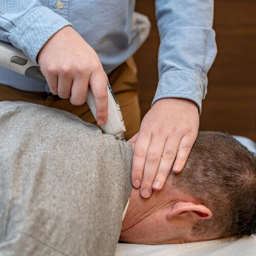 Chiropractor treating patient with Activator Method