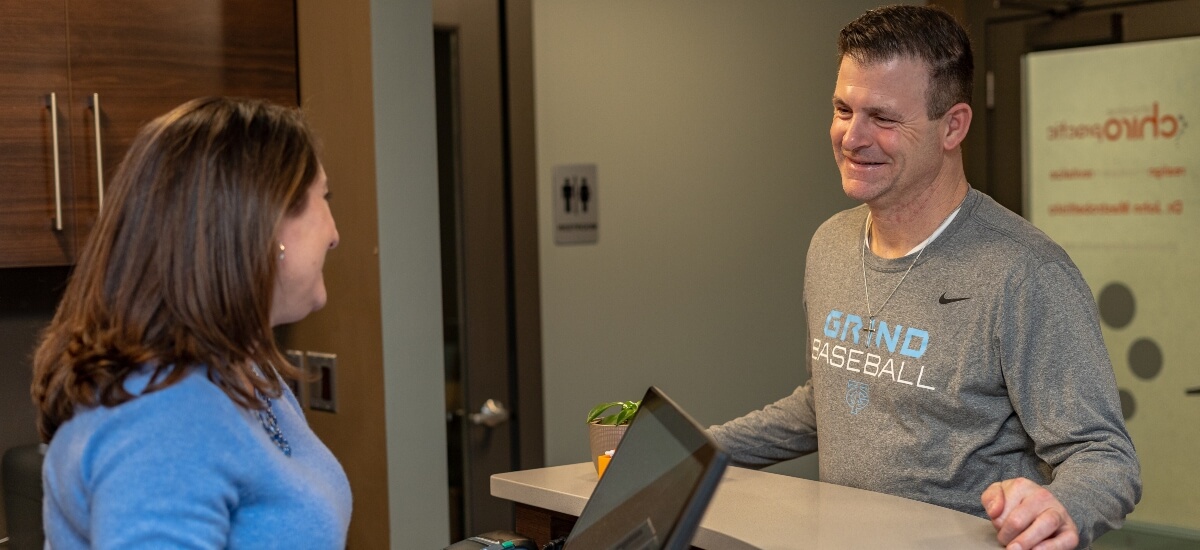 Receptionist talking to patient