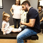 Dr. Nick with child on adjusting table