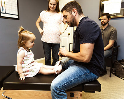 Dr. Nick with child on adjusting table