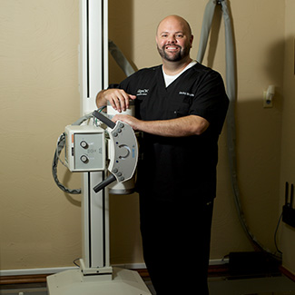 Dr. Kyle standing by xray machine