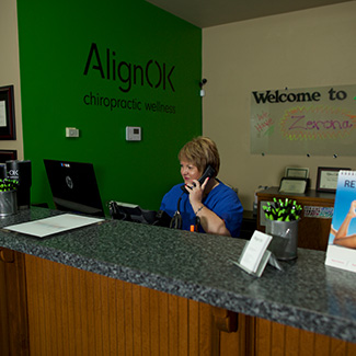 Jill on the phone at the front desk