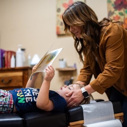 Mobile chiropractor Dr Quinn adjusting child