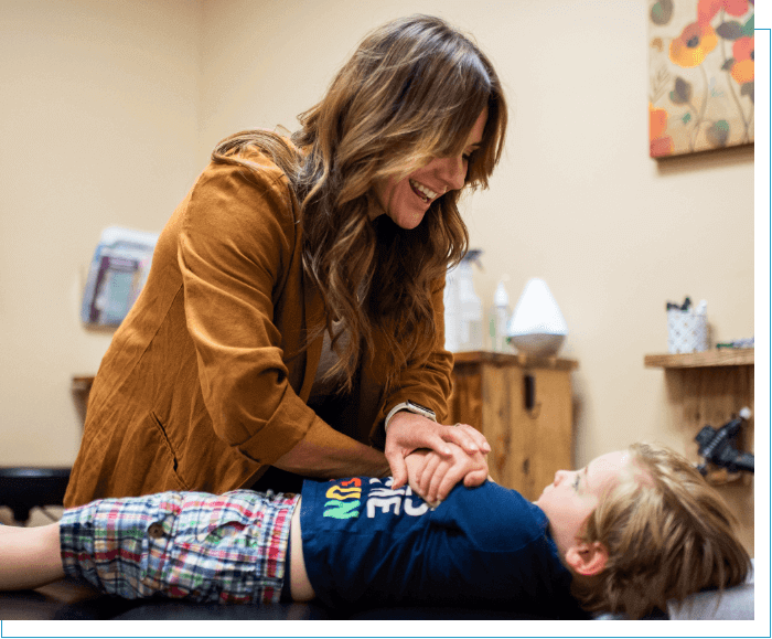 Mobile chiropractor Dr Kennedy adjusting toddler