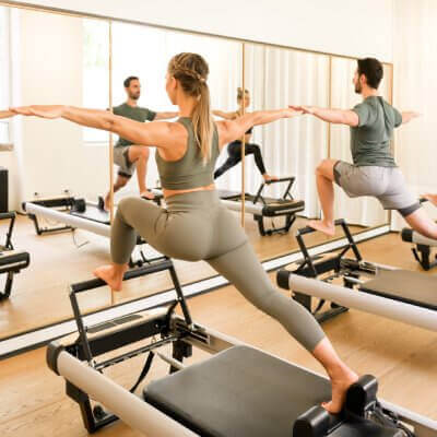group doing pilates in front of mirror