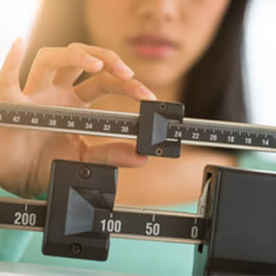 Woman checking weight on scale