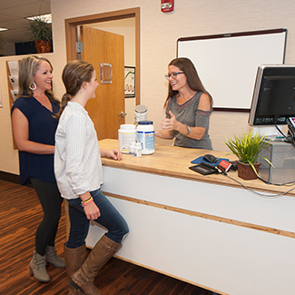 Receptionist greeting patients