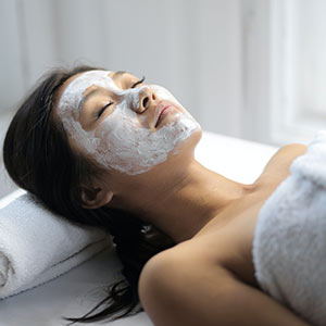 woman with facial spa mask on