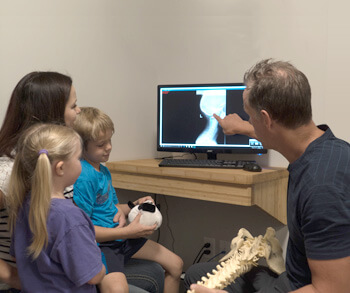 Dr. Gray showing xrays to children