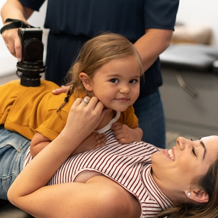 baby girl on top of mom