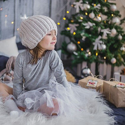 Smiling young child sitting with gifts