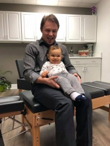 doctor and infant patient sitting on an adjusting table