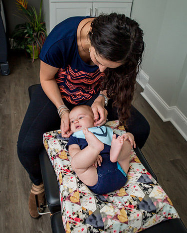 chiropractor adjusting a baby