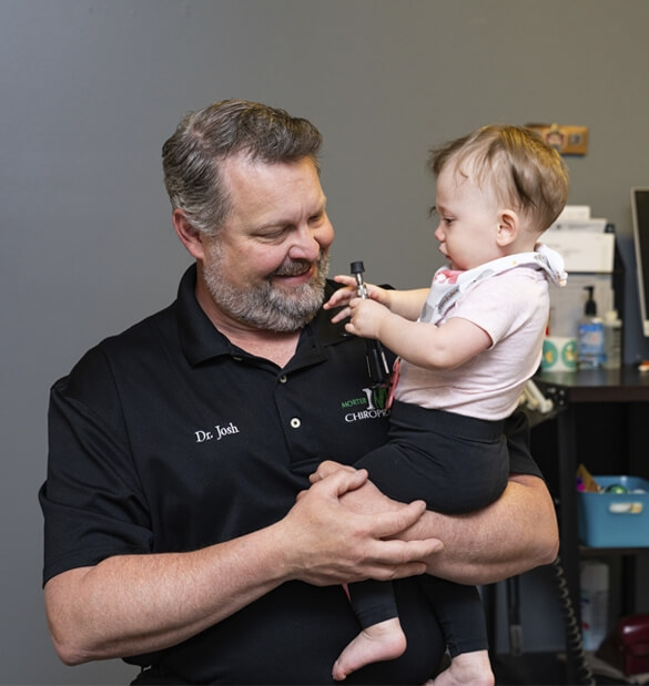 Murfreesboro chiropractor Dr. Josh holding a baby