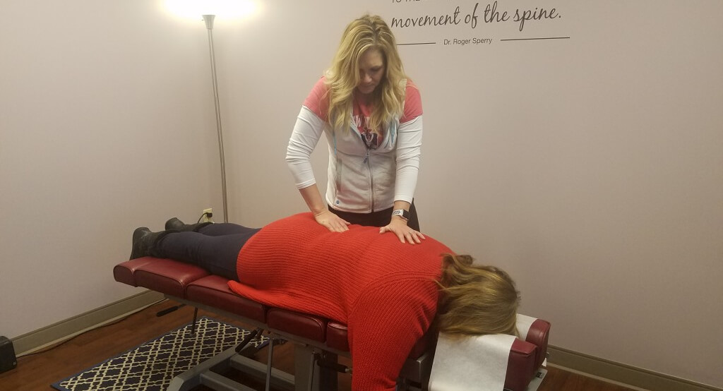 Painesville chiropractor adjusting a female patient