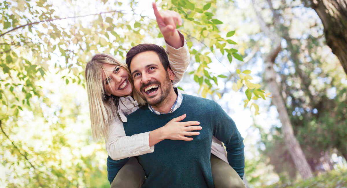Smiling man and woman out in nature