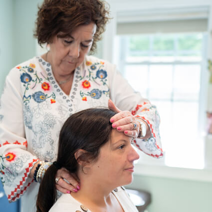 Female patient getting her neck adjusted