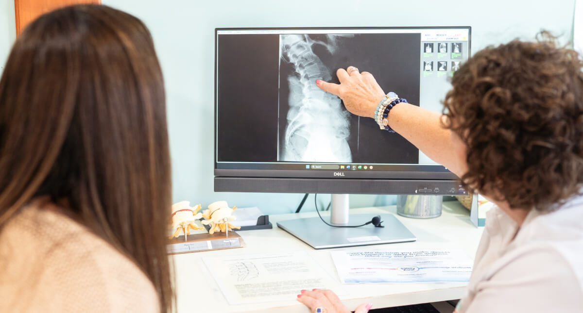 Stoughton chiropractor discussing x-ray results with patient