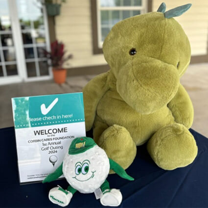welcome table with stuffed animal dinosaur